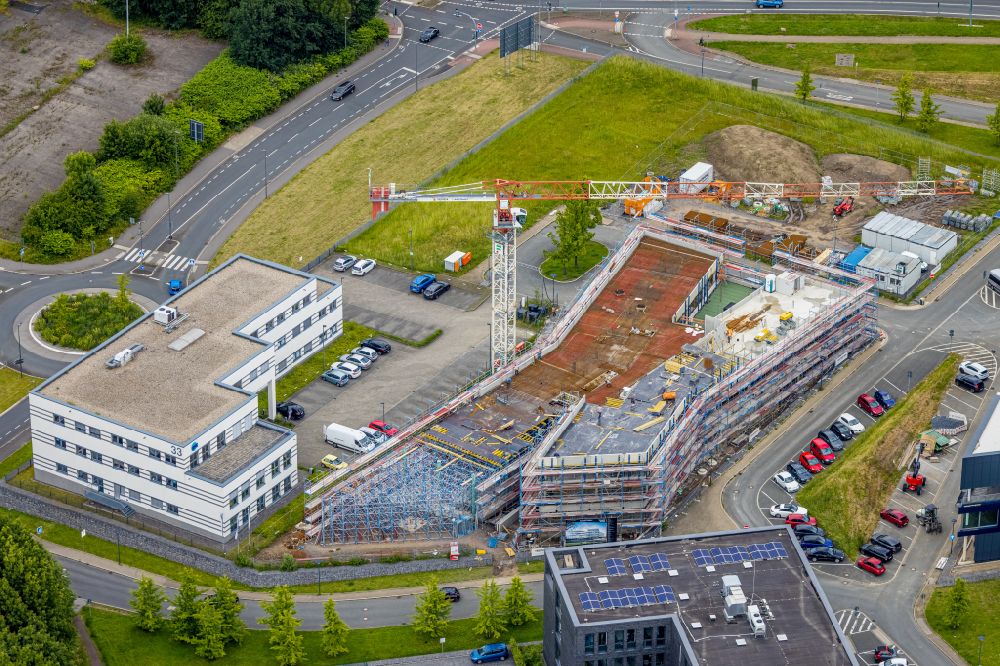 Bochum from the bird's eye view: Construction site for the new building of an Office building - Ensemble Buerohauses of Firma Cosinex on street Gesundheitscampus-Sued in the district Querenburg in Bochum at Ruhrgebiet in the state North Rhine-Westphalia, Germany