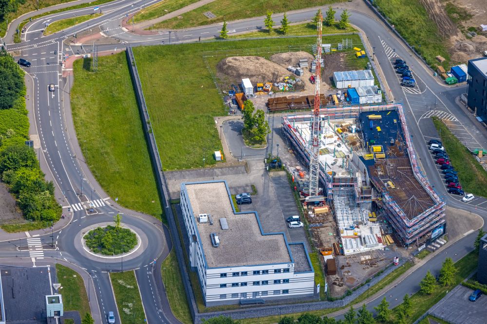 Bochum from the bird's eye view: Construction site for the new building of an Office building - Ensemble Buerohauses of Firma Cosinex on street Gesundheitscampus-Sued in the district Querenburg in Bochum at Ruhrgebiet in the state North Rhine-Westphalia, Germany