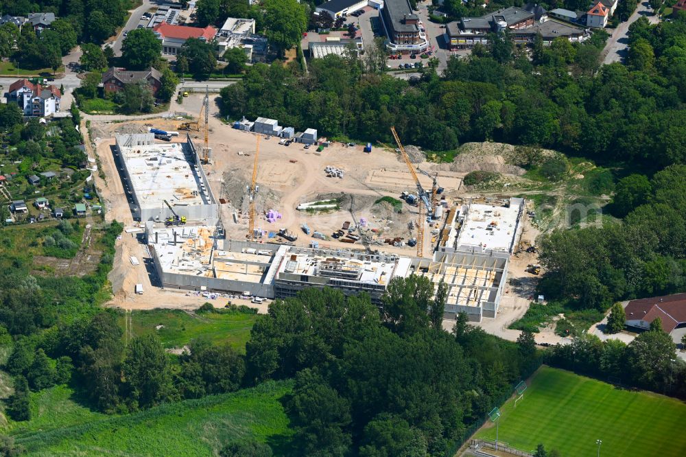 Aerial image Hansestadt Wismar - New construction of the building complex of the shopping center on street Schweriner Strasse in Hansestadt Wismar at the baltic sea coast in the state Mecklenburg - Western Pomerania, Germany