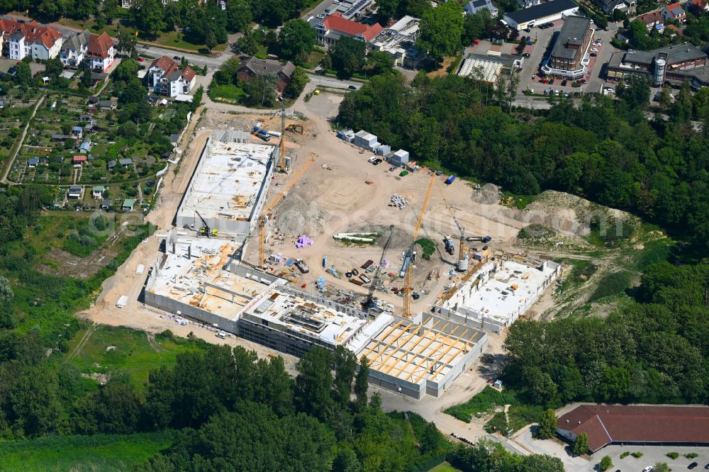 Aerial photograph Hansestadt Wismar - New construction of the building complex of the shopping center on street Schweriner Strasse in Hansestadt Wismar at the baltic sea coast in the state Mecklenburg - Western Pomerania, Germany