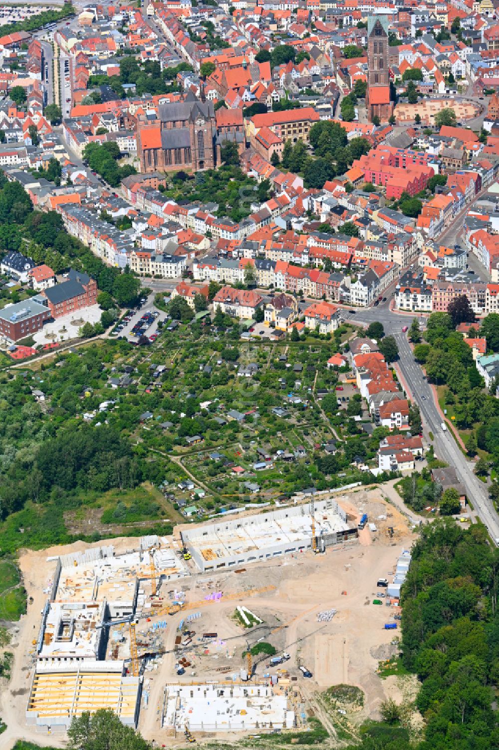 Aerial photograph Hansestadt Wismar - New construction of the building complex of the shopping center on street Schweriner Strasse in Hansestadt Wismar at the baltic sea coast in the state Mecklenburg - Western Pomerania, Germany