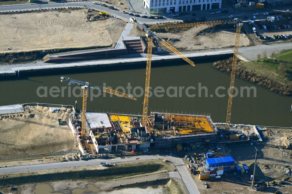 Hamburg from the bird's eye view: Construction site for new high-rise building complex Roots on street Versmannstrasse - Lucy-Borchardt-Strasse on Baakenhafen in the district HafenCity in Hamburg, Germany