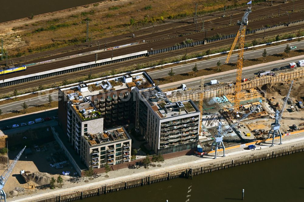 Hamburg from the bird's eye view: Construction site for new high-rise building complex Roots on street Versmannstrasse - Lucy-Borchardt-Strasse on Baakenhafen in the district HafenCity in Hamburg, Germany