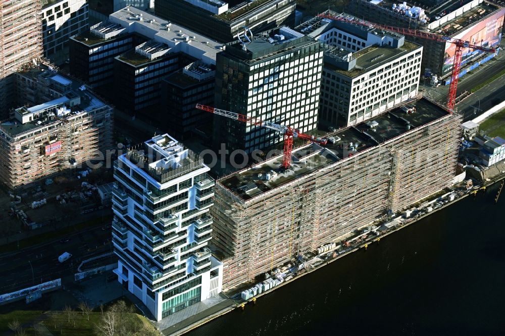Berlin from above - New construction site the hotel complex PIER 61|63 on Muehlenstrasse in Berlin, Germany. In the foreground, the high-rise new building Living Levels on the banks of the Spree river course