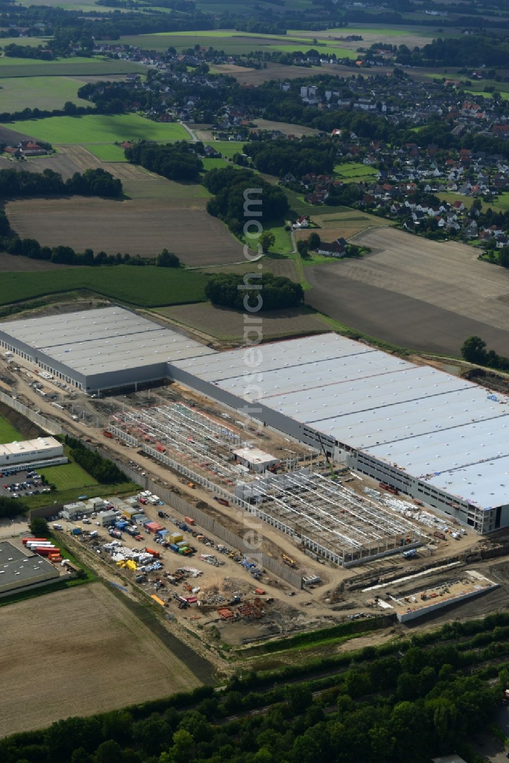 Aerial image Löhne - Construction site for the new building the logistics center of Hermes Fulfilment in the industrial area Scheid Kamp in Loehne in the state North Rhine-Westphalia. Under the project leadership of the ECE Projektmanagement GmbH & Co. KG erected the construction company GOLDBECK GmbH the logistics hall complex