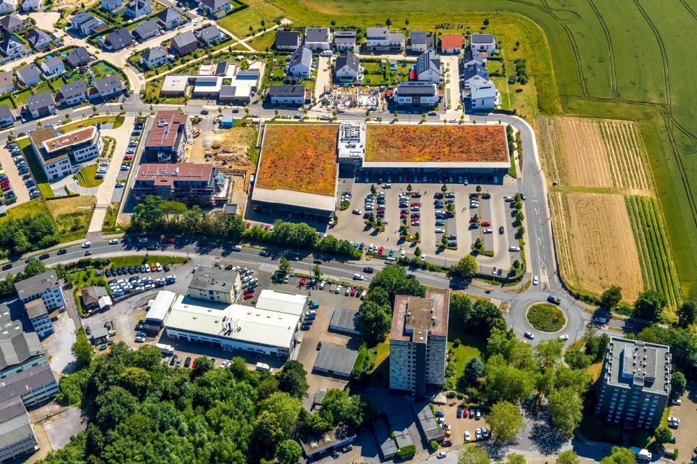 Aerial photograph Heiligenhaus - Construction site for the construction of a multi-family residential complex Haus Selbeck and the local supply center in Heiligenhaus in the federal state of North Rhine-Westphalia, Germany