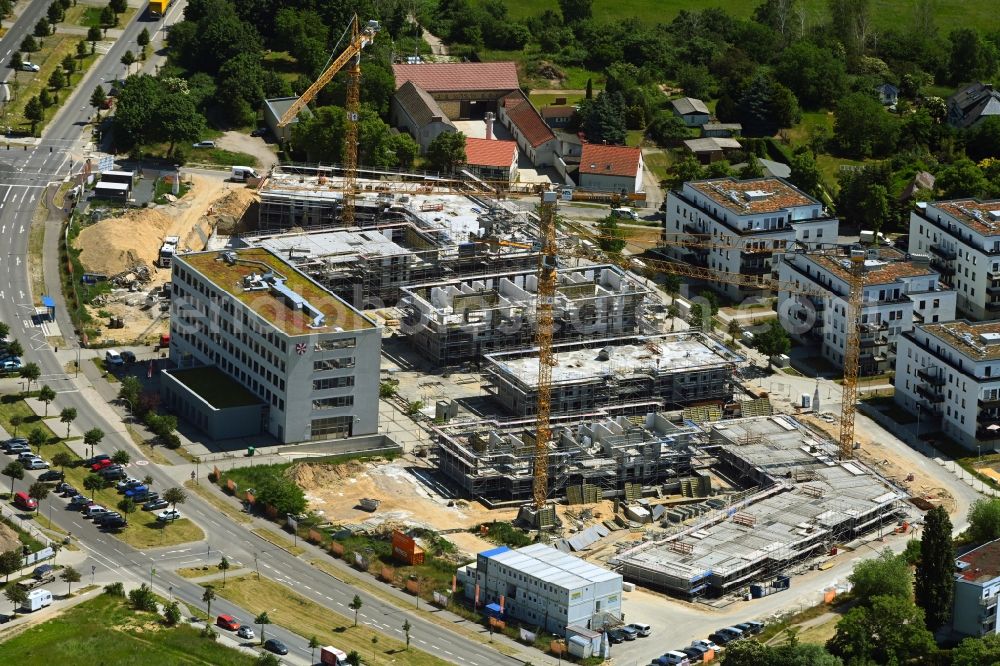 Schönefeld from the bird's eye view: Construction site to build a new multi-family residential complex Neue Mitte on Hans-Grade-Allee - Grossziethener Weg - Am Schoenefeld in Schoenefeld in the state Brandenburg, Germany