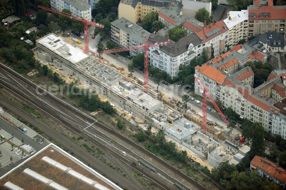 Berlin from above - Construction site to build a new multi-family residential complex in the Halensee part of the district of Charlottenburg-Wilmersdorf in Berlin in Germany. The construction site is located on Seesener Strasse, on railway tracks. A modern residential complex with business areas is being created