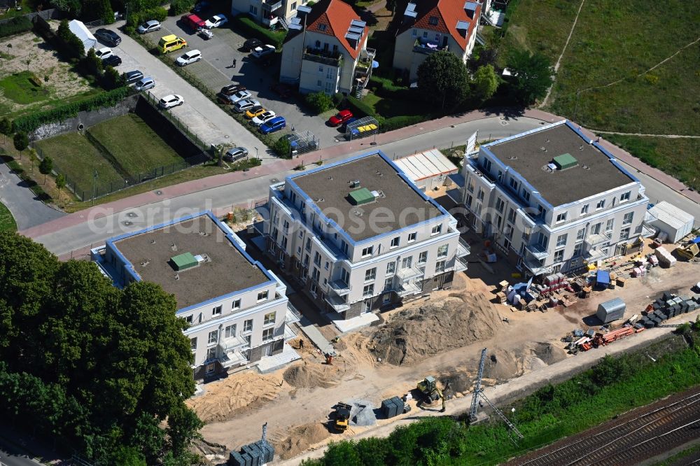 Aerial photograph Bergfelde - Construction site for the new residential and commercial building on Brueckenstrasse in Bergfelde in the state Brandenburg, Germany