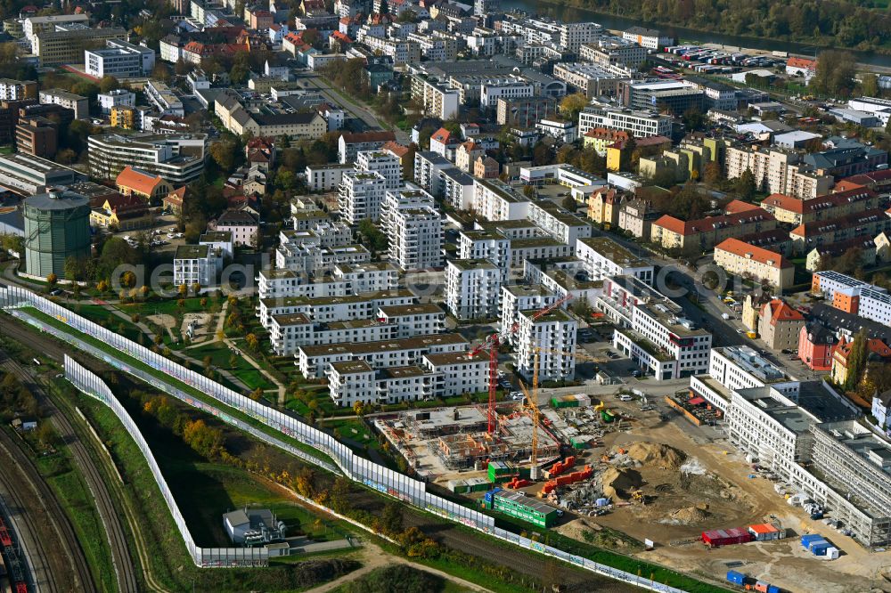 Regensburg from the bird's eye view: Construction site for the construction of a multi-family residential and commercial building on Edith-Stein-Strasse - Zuckerfabrikstrasse - Straubinger Strasse in the district of Ostenviertel in Regensburg in the state Bavaria, Germany