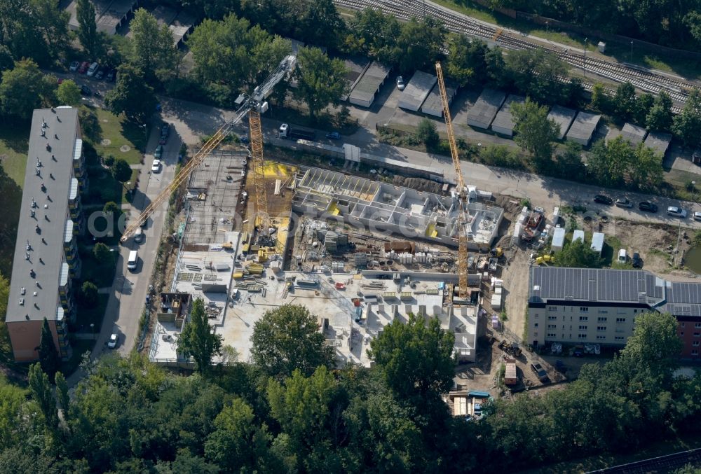 Berlin from above - Construction site for the multi-family residential building on Hartriegelstrasse - Moosstrasse in the district Niederschoeneweide in Berlin, Germany