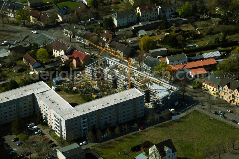 Hennigsdorf from the bird's eye view: Construction site for the multi-family residential building of the new building project Albert-Schweitzer-Quartier on Berliner Strasse in Hennigsdorf in the state Brandenburg, Germany