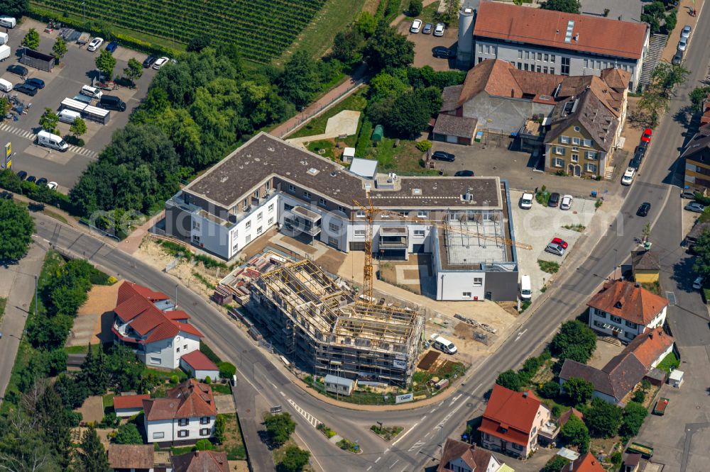 Oberrotweil from the bird's eye view: Construction site for the multi-family residential building on street Bahnhofstrasse in Oberrotweil in the state Baden-Wuerttemberg, Germany