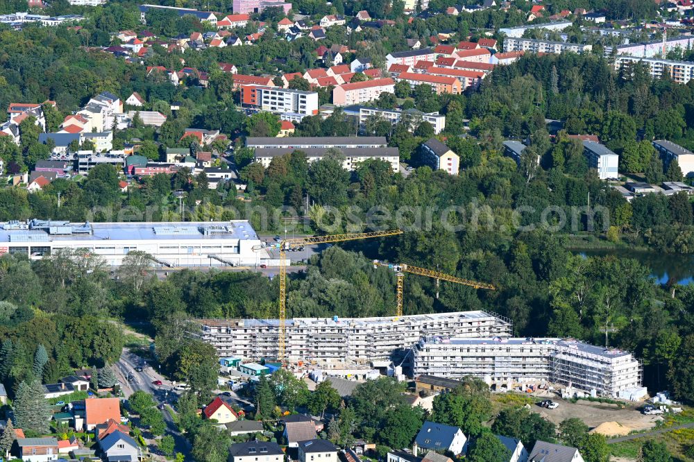 Bernau from the bird's eye view: Construction site for the multi-family residential building of Projekts Panke Aue on Schoenfelder Weg in Bernau in the state Brandenburg, Germany