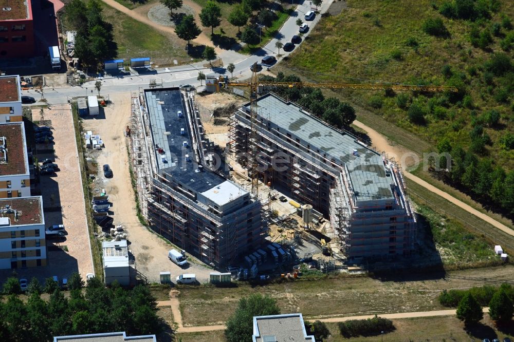 Schönefeld from the bird's eye view: Construction site for the multi-family residential building Theodor-Fontane-Hoefe on Theodor-Fontane-Allee - Bayangolpark in Schoenefeld in the state Brandenburg, Germany