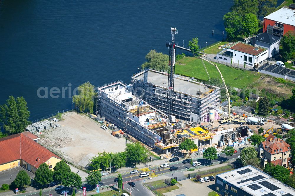 Berlin from above - Construction site for the multi-family residential building on the banks of the Spree river on street Schnellerstrasse in the district Schoeneweide in Berlin, Germany