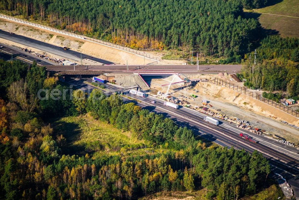 Michendorf from the bird's eye view: Construction for the renovation of the railway bridge building to route the train tracks crossing course of motorway BAB A10 in Michendorf in the state Brandenburg