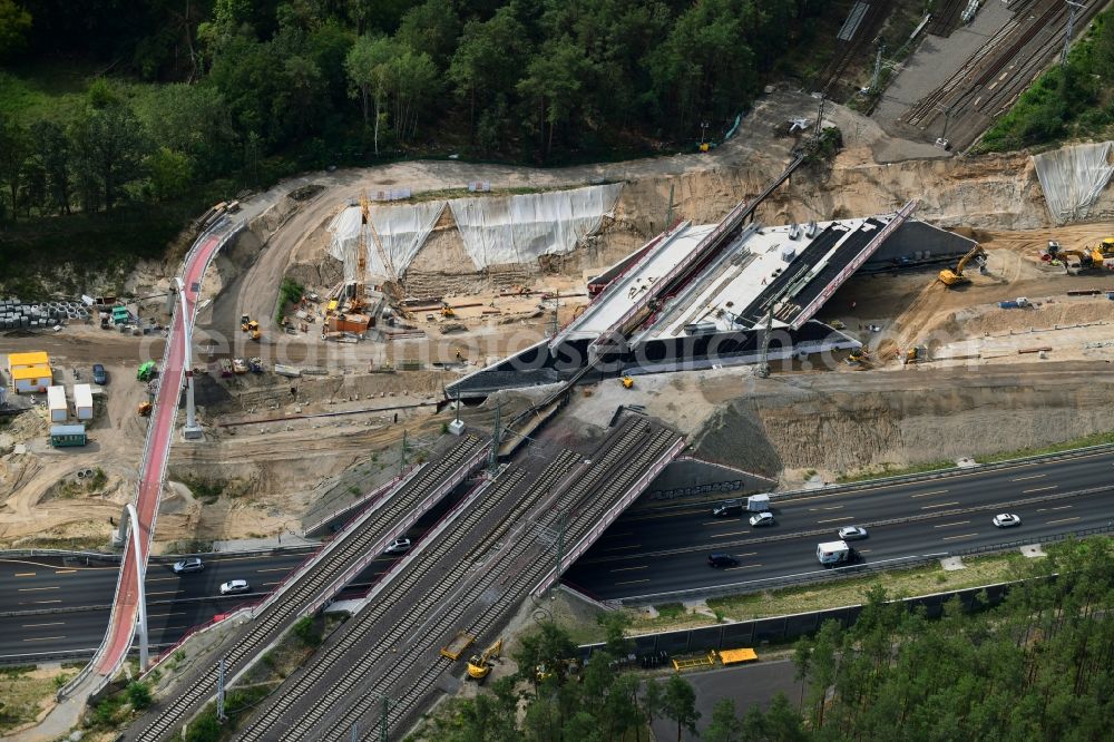 Michendorf from above - Construction for the renovation of the railway bridge building to route the train tracks crossing course of motorway BAB A10 in Michendorf in the state Brandenburg
