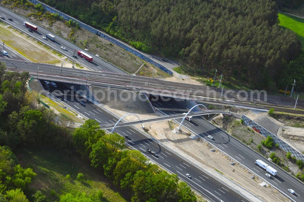 Michendorf from the bird's eye view: Construction for the renovation of the railway bridge building to route the train tracks crossing course of motorway BAB A10 in Michendorf in the state Brandenburg