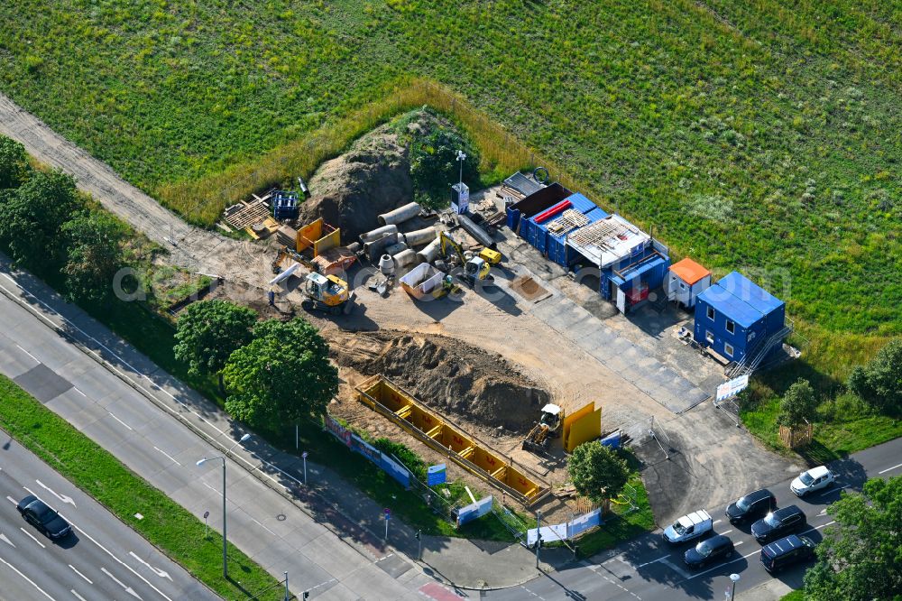 Berlin from the bird's eye view: Construction site with earthworks and landfills for the laying of pipelines of the Berliner Wasserbetriebe on street B1- Kressenweg in the district Mahlsdorf in Berlin, Germany