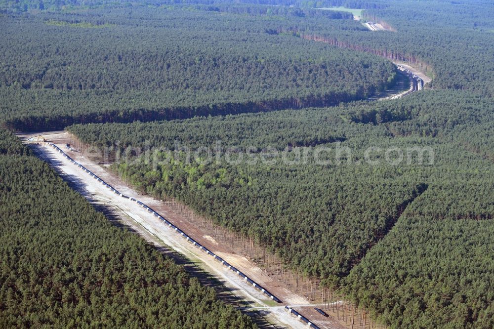 Groß Köris from the bird's eye view: Construction site with earthworks and landfills for the laying of pipelines of the new European Gas Lines (Eugal) in a forest in einem Wald in Gross Koeris in the state Brandenburg, Germany
