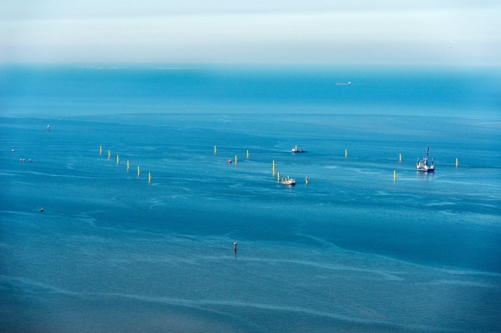 Wangerland from the bird's eye view: Construction site for wind turbine installation In an offshore wind farm on the sea surface of the North Sea in the district Schillig in Wangerland in the state Lower Saxony