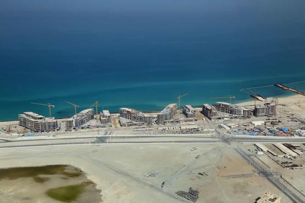 Aerial photograph Abu Dhabi - Construction sites for new residential Areas and hotels at the coast of Persian Gulf on Saadiyat Island in Abu Dhabi in United Arab Emirates