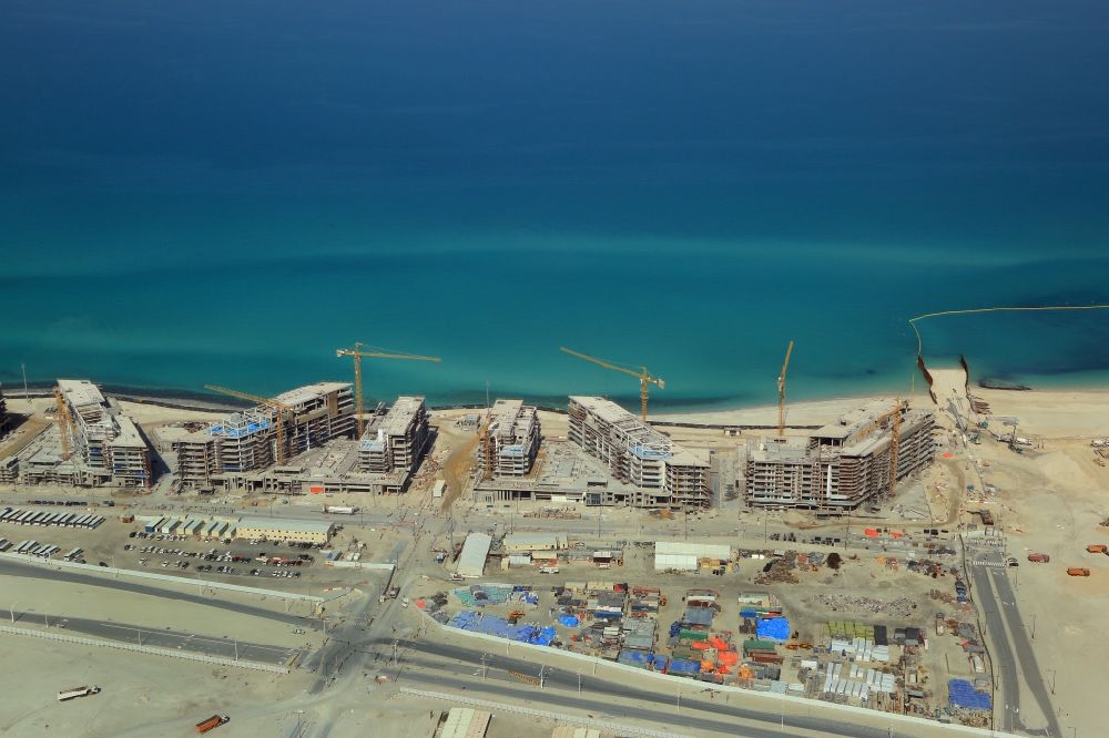 Abu Dhabi from above - Construction sites for new residential areas and hotels at the coast of Persian Gulf on culture Island Saadiyat in Abu Dhabi in United Arab Emirates