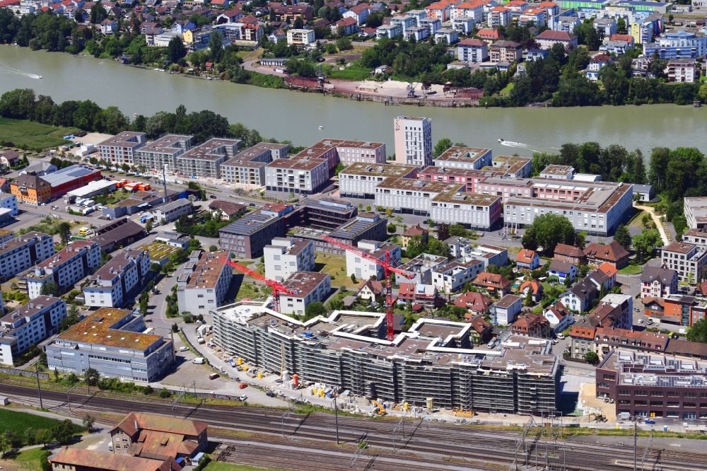 Rheinfelden from above - Construction site for City Quarters Building Furnierwerk with housing and commercial units and the expansion of Salmenpark at the river Rhine in Rheinfelden, canton Aargau, Switzerland