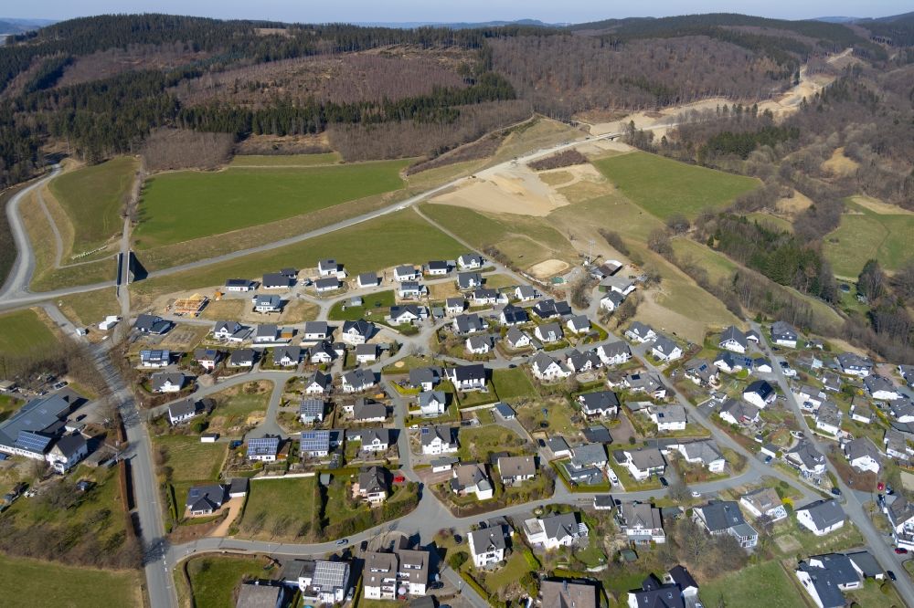 Schmallenberg from the bird's eye view: Construction sites for new construction residential area of detached housing estate on the bypass at Rohdauweg - Buchhagenweg - Am Kapellenberg in the district Bad Fredeburg in Schmallenberg at Sauerland in the state North Rhine-Westphalia, Germany