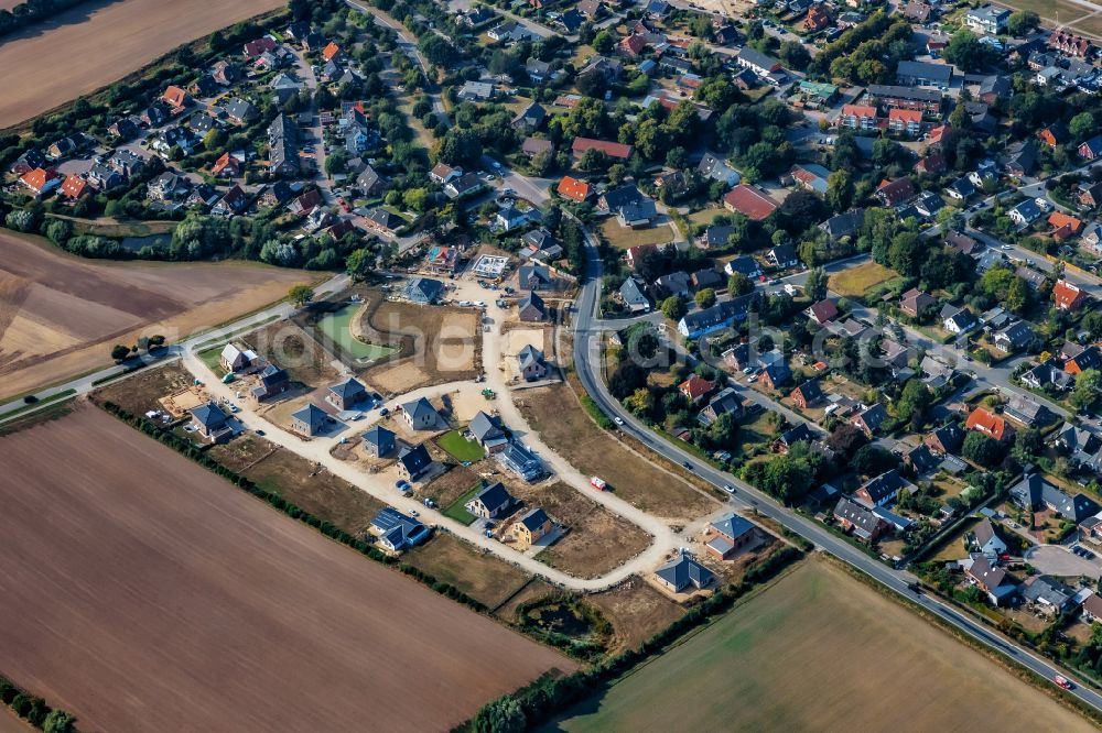 Stein from above - Construction sites for new construction residential area of detached housing estate on street Kirchkoppel in Stein in the state Schleswig-Holstein, Germany