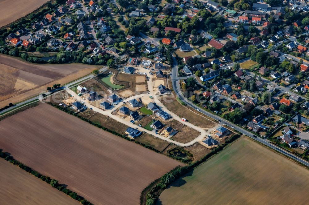 Stein from the bird's eye view: Construction sites for new construction residential area of detached housing estate on street Kirchkoppel in Stein in the state Schleswig-Holstein, Germany