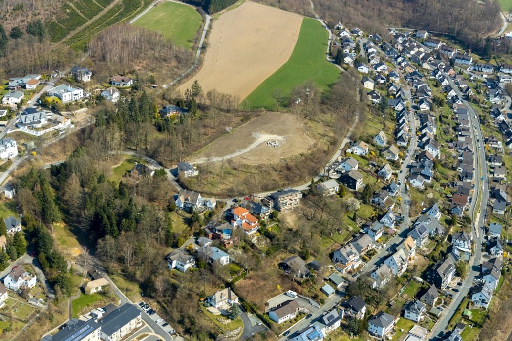 Meschede from the bird's eye view: Construction sites for new construction residential area of detached housing estate Unterm Hasenfeld in Meschede in the state North Rhine-Westphalia, Germany