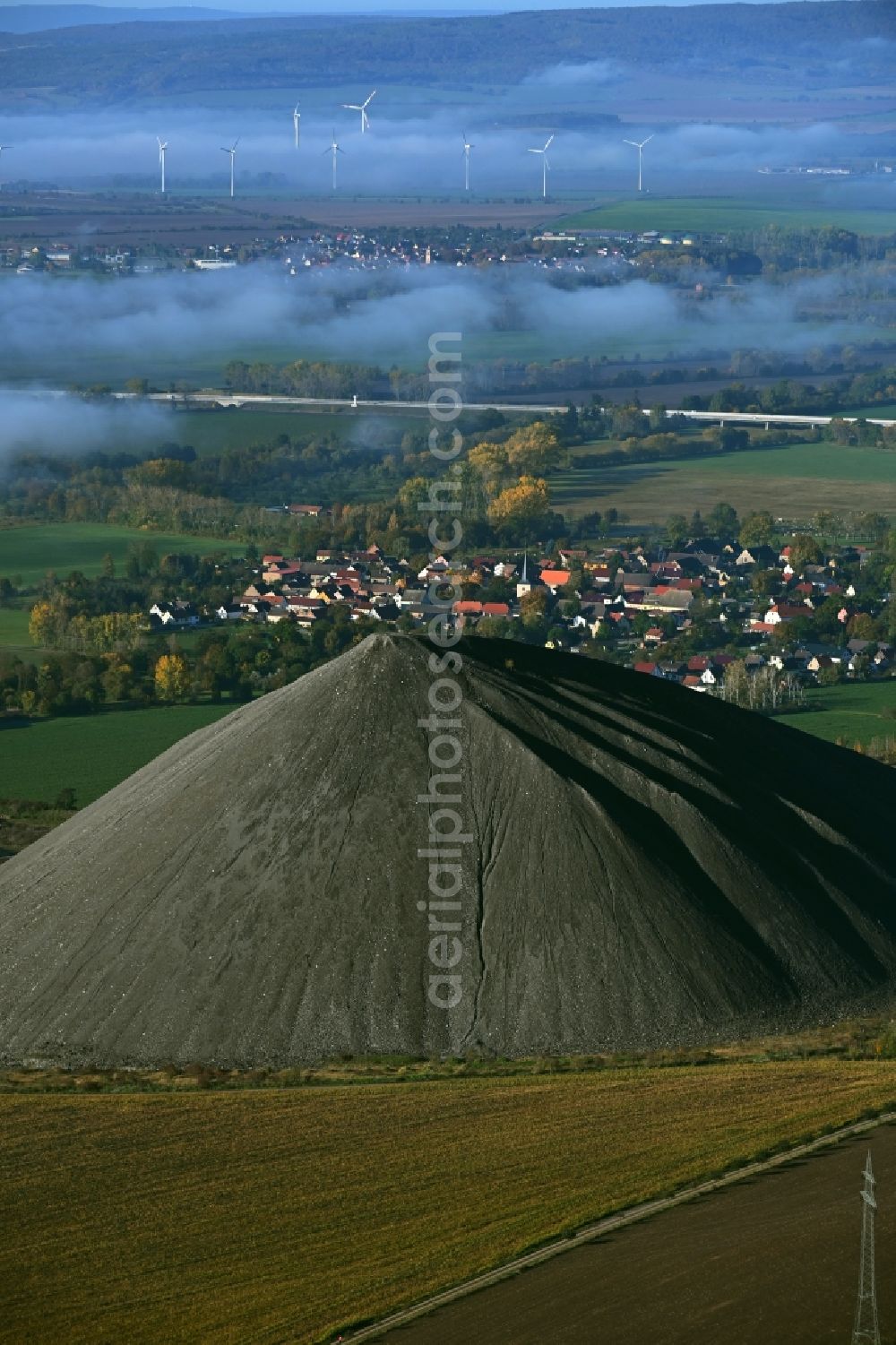 Aerial image Niederröblingen (Helme) - Layers of a mining waste dump of copper mining in front of a layer of high fog in Niederroeblingen (Helme) Mannsfelder Land in the state Saxony-Anhalt, Germany