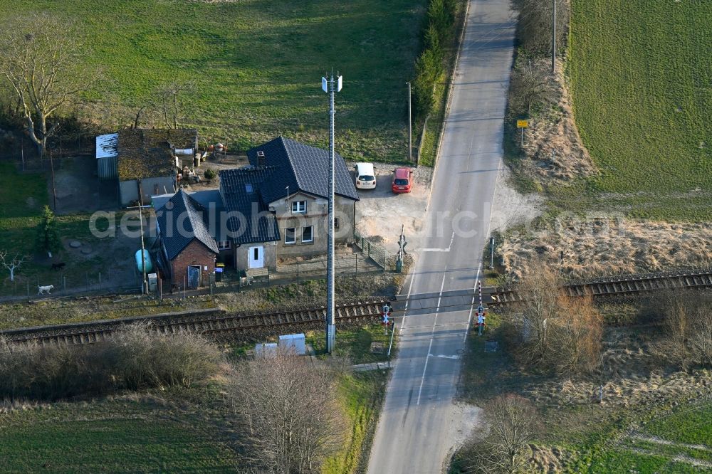 Groß Daberkow from above - Roads - barriers at a level crossing in the rail track route network of the Deutsche Bahn with old gate keeper's house in Gross Daberkow in the state Mecklenburg - Western Pomerania, Germany