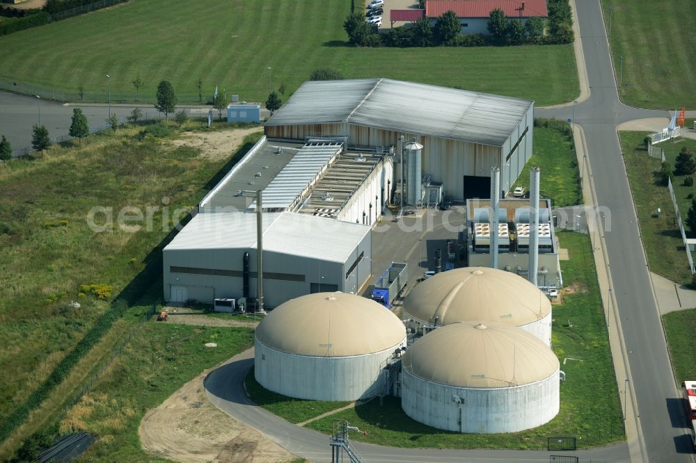 Jessen (Elster) from above - Biogas compound of Agratec in the commercial park of Jessen (Elster) in the state of Saxony-Anhalt. The compound with the tanks and silos is surrounded by fields and meadows