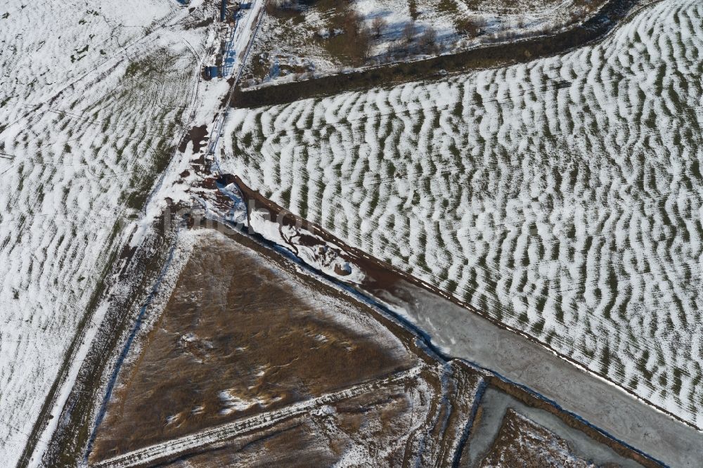 Bittstädt from the bird's eye view: Winter snowy field structures in Bittstaedt in Thuringia