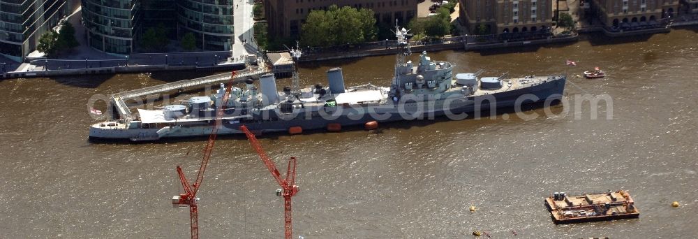Aerial image Riverside Ward - View of the British warship HMS Belfast on the Thames in London. The ship, which was built in 1936 and belongs to the Town-class, was the largest light cruiser of the Royal Navy during World War II. It is anchored on the Thames and is now a museum