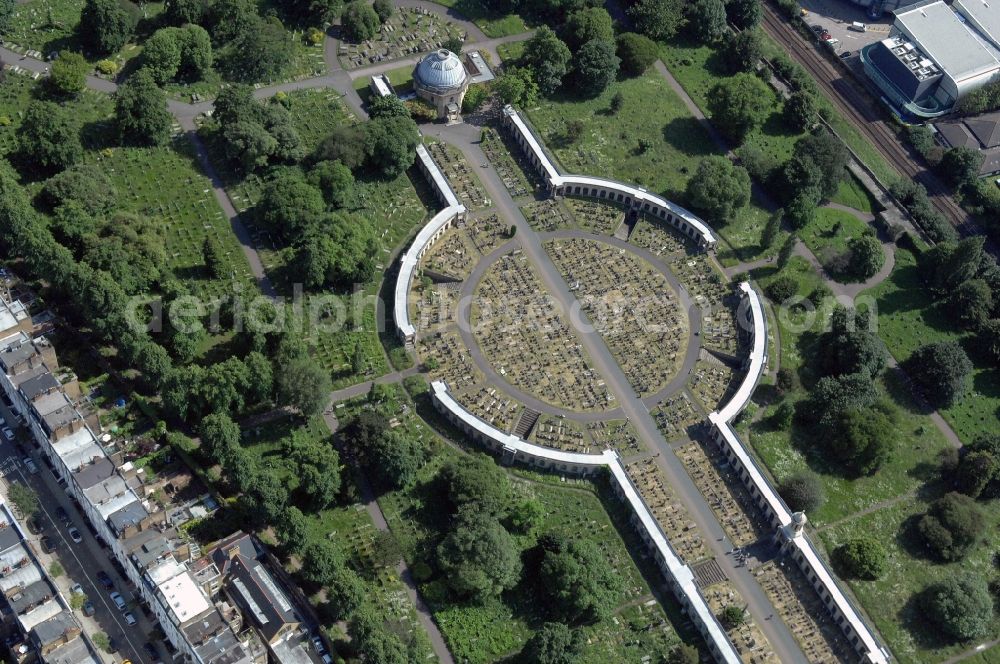 Aerial photograph London - View of the Brompton Cemetery in London. The place is located near Earl's Court, West Brompton, a part of the Royal Borough of Kensington and Chelsea, southwest London. It opened in 1840 under the name West of London and Westminster Cemetery and is one of the Magnificent Seven in London. The facility is managed by The Royal Parks, the Royal Park Administration. The cemetery was created following an Act of Parliament to improve the disastrous lack of space for burials in London, which had led to intolerable hygienic conditions in the city the former years. The construction is still used for occasional funerals, but is more and more as a park
