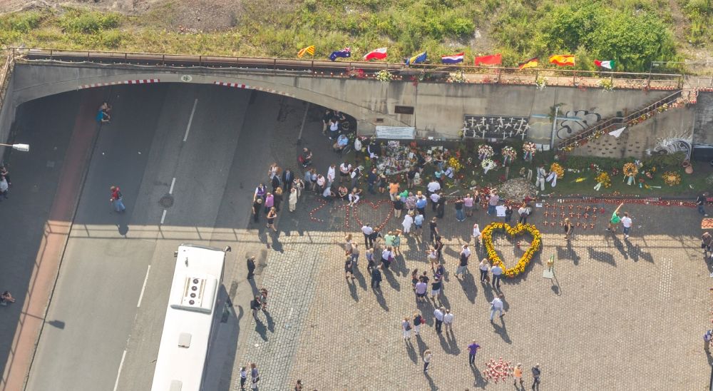 Aerial image Duisburg - View of the second anniversary commemoration of the Love Parade disaster in Duisburg. At the Karl-Lehr tunnel, were in 2010 21 people died during a stampede at the event of the Love Parade, the victims were commemorated two years after the accident. Members showed their grief with flowers and grave lights at the accident site near the railway station