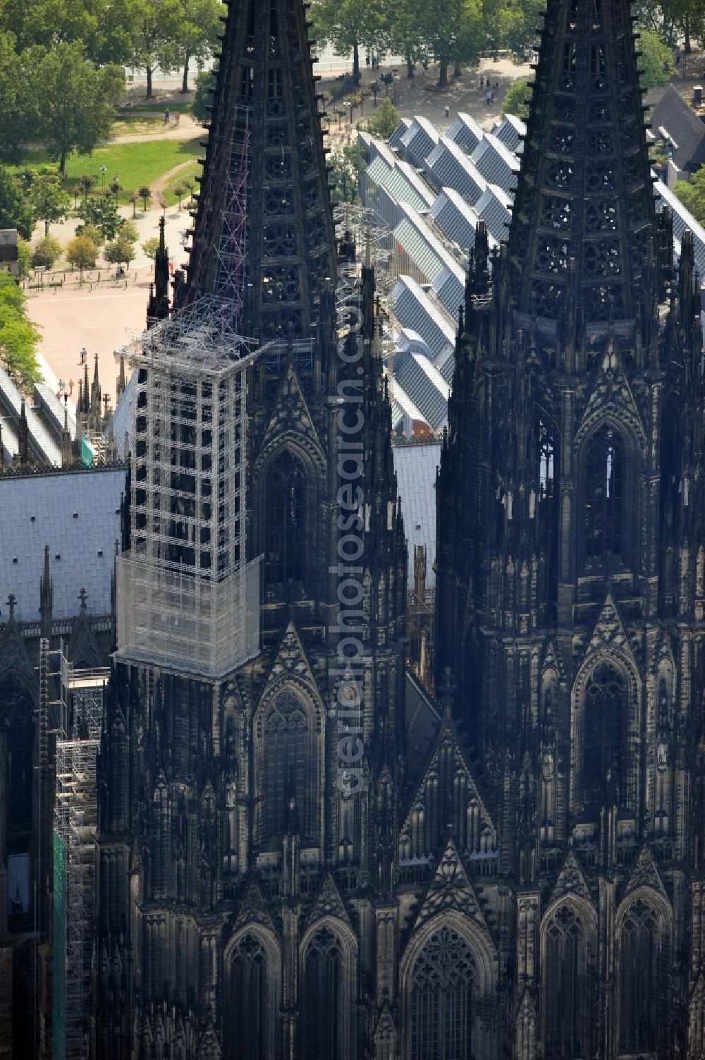 Aerial photograph Köln - View of the Cologne Cathedral with scaffolding on the north tower.The the 157-meter high Gothic building, whose construction started in 1248 and was completed in 1880, belongs to the UNESCO World Heritage since 1996 and is redeveloped again and again. Currently, two frameworks are at the north tower of the cathedral, thus the stonemasons can expand the connecting elements of the sandstone, restore angel figurines and fix old war damage