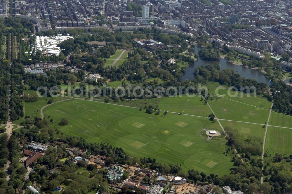 London from the bird's eye view: View of the royal Regent's Park, London. It is located in the northern part of the centre of London Boroughs in the City of Westminster and Camden. The two-square-mile area is surrounded by a ring road, the Outer Circle. In the centre is an inner ring road, the Inner Circle. The latter surrounds the Queen Mary's Gardens, the most carefully cultivated part of the park. The southern, eastern and most of the park boundary are surrounded by white row houses, which were designed by the architect John Nash in the 19th century. The north of the park is bordered by Regent's Canal, which connects the Grand Union Canal with the Docklands. The park consists mainly of a meadow landscape and recreational facilities