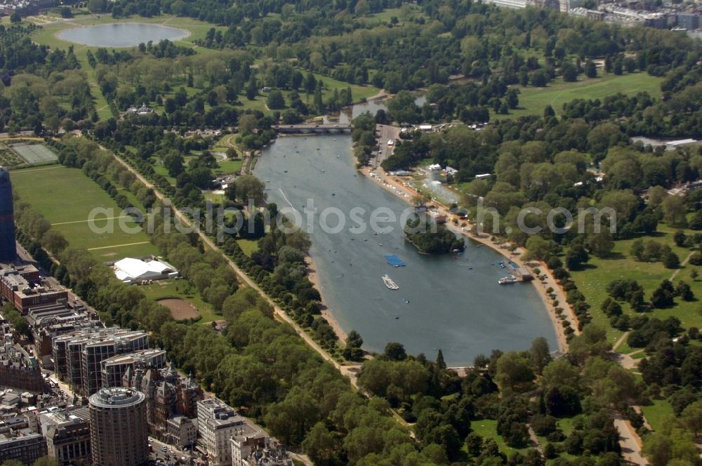 London from above - View of the lake The Serpentine in London. The 11-acre tall lake is largely based in Hyde Park, while the North End belongs to the Kensington Gardens. It was created in 1730 by order of Queen Caroline by damming the River Westbourne, and now serves a variety of leisurely activities such as swimming, boating and fishing