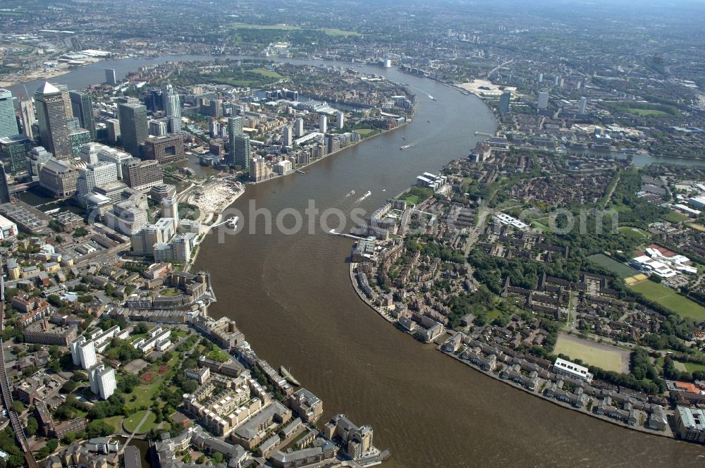 Aerial photograph London - View of the Thames at the Isle of Dogs in London. The peninsula is located in the East End of London and the west, south and east is surrounded by the River Thames. The Isle of Dogs is part of the district of London Borough of Tower Hamlets and forms part of the Docklands