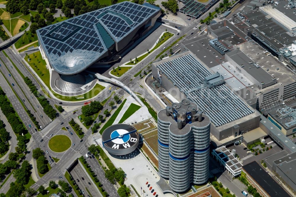 München from the bird's eye view: The BMW Welt is a combined exhibition, delivery, adventure, museum and event venue in Munich in Bavaria and is part of the corporate headquarters of the car manufacturer BMW. In the so-called brand world, an exhibition pavilion, the current models of BMW, MINI, Rolls-Royce Motor Cars and BMW Motorrad, innovations and technology are presented. On the roof of the multifunctional building a solar power plant produces electricity. Architect of the building are Prof. Wolf D. Prix and the architectural firm Coop Himmelb (l) au