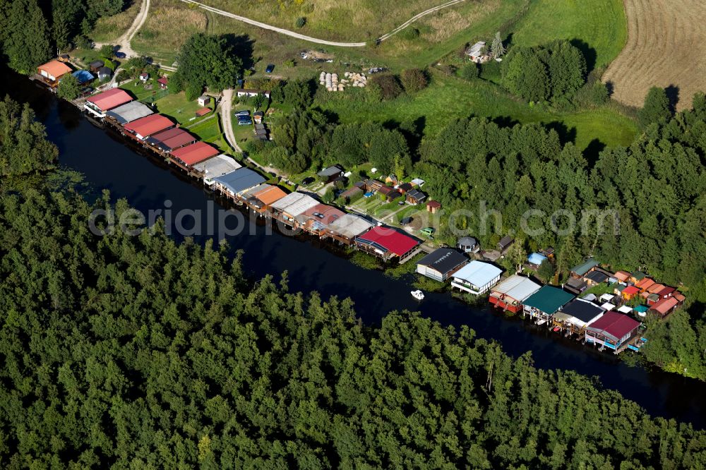 Aerial photograph Mirow - Boat House ranks with the recreational marine jetties and boat mooring area on the banks of the canal of the Mecklenburg Lake District in Mirow in the state Mecklenburg - Western Pomerania, Germany