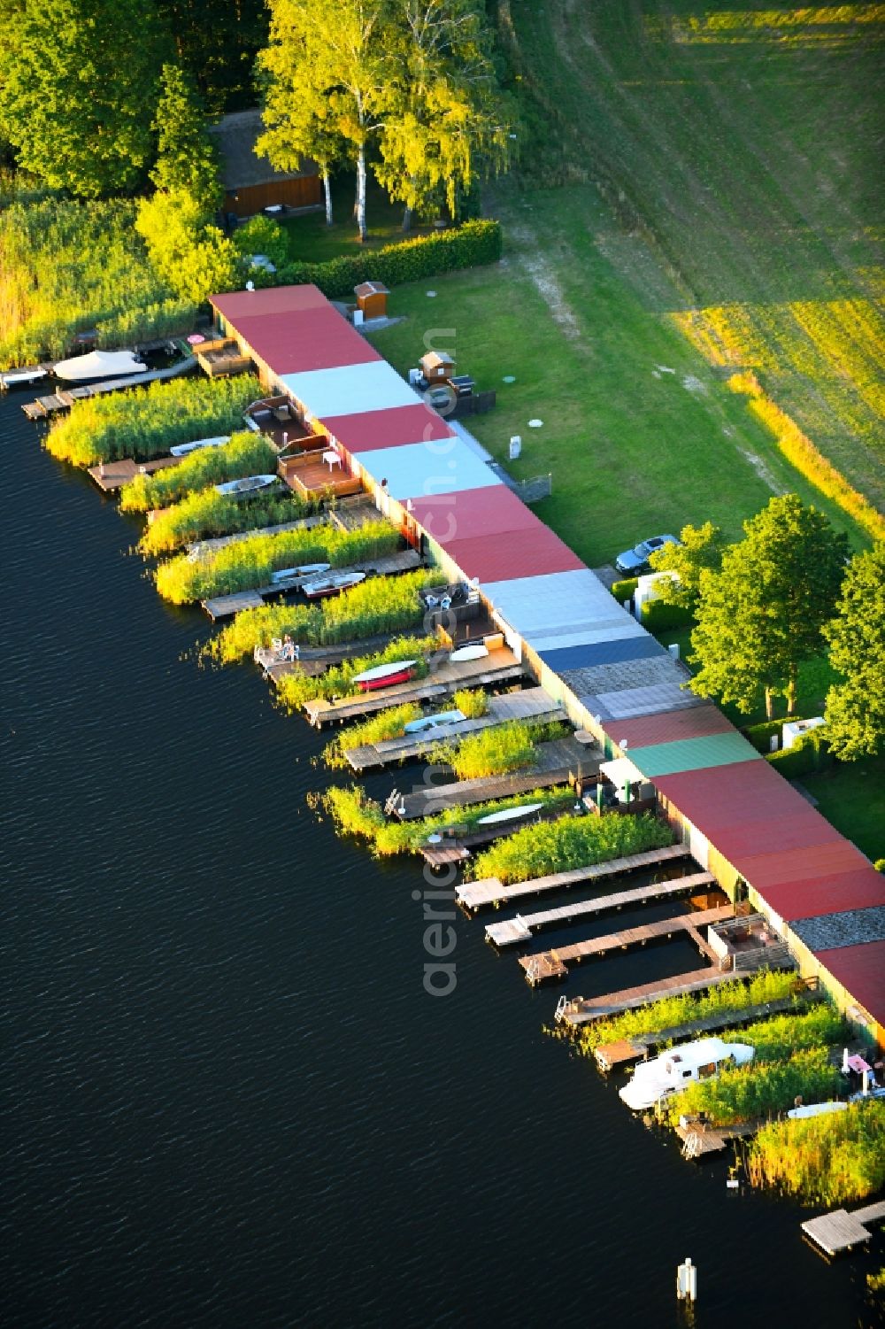 Aerial photograph Schillersdorf - Boat House ranks with the recreational marine jetties and boat mooring area on the banks of Leppinsee in Schillersdorf in the state Mecklenburg - Western Pomerania, Germany