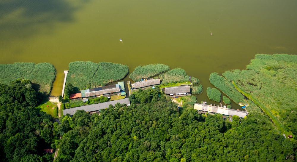 Seedorf from the bird's eye view: Boat House ranks with the recreational marine jetties and boat mooring area on the banks des Malchiner Sees in Seedorf in the state Mecklenburg - Western Pomerania