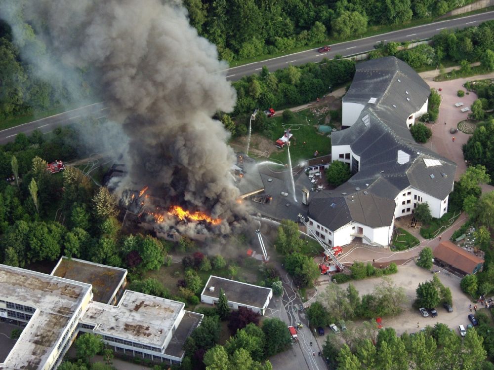 Aerial image Schopfheim - Large fire at the gym of the Waldorf School in Schopfheim in Baden-Wuerttemberg. The fire department in operation. The smoke cloud passes over the residential area