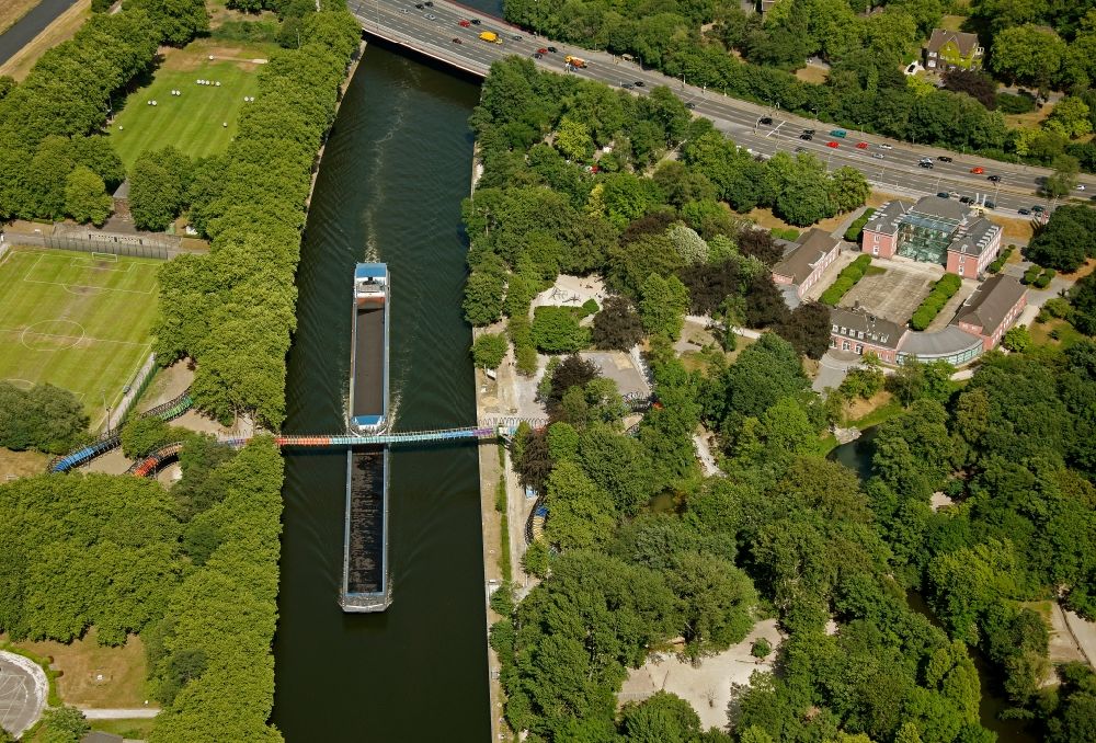 Aerial image Oberhausen - View of the bridge Slinky Springs to Fame in Oberhausen in North Rhine-Westphalia. The bridge sculpture with spiral over the Rhine-Herne-Kanal was conceived within the framework of the art project Emscherkunst.2010 by the sculptor Tobias Rehberger in collaboration with the engineering firm Schlaich, Bergemann and Partner and opened in 2011. The pedestrian and bicycle bridge connects the garden of the castle with the Emscherinsel